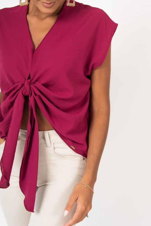 Asymmetrical blouse with knot detail