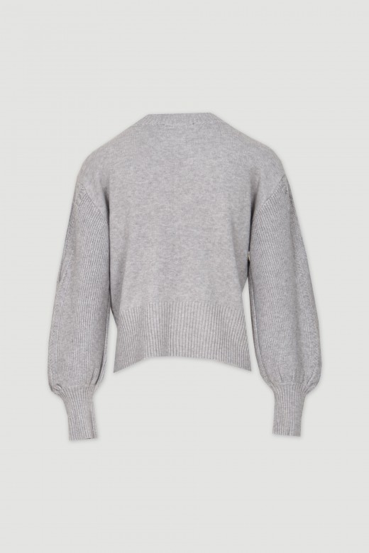 Knit sweater with reliefs and perforations