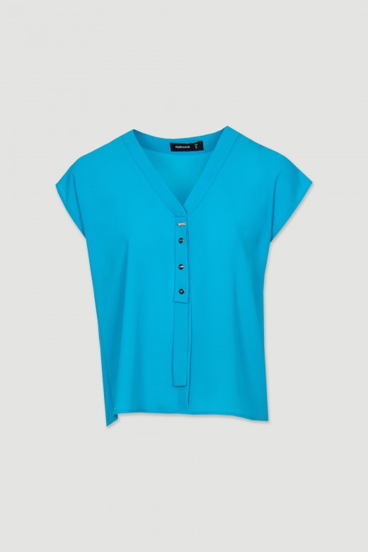 Blouse with button application