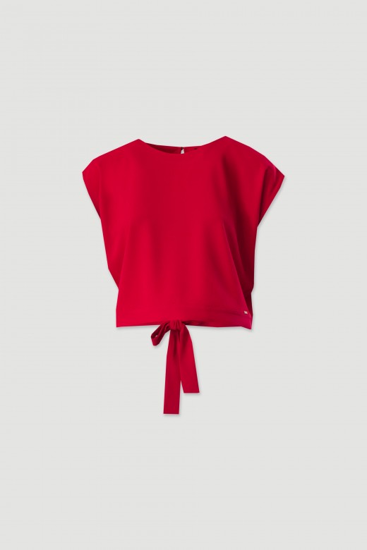 Short blouse with button fastening and tie at the back