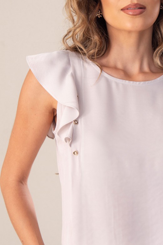 Blouse unie avec volant sur la manche