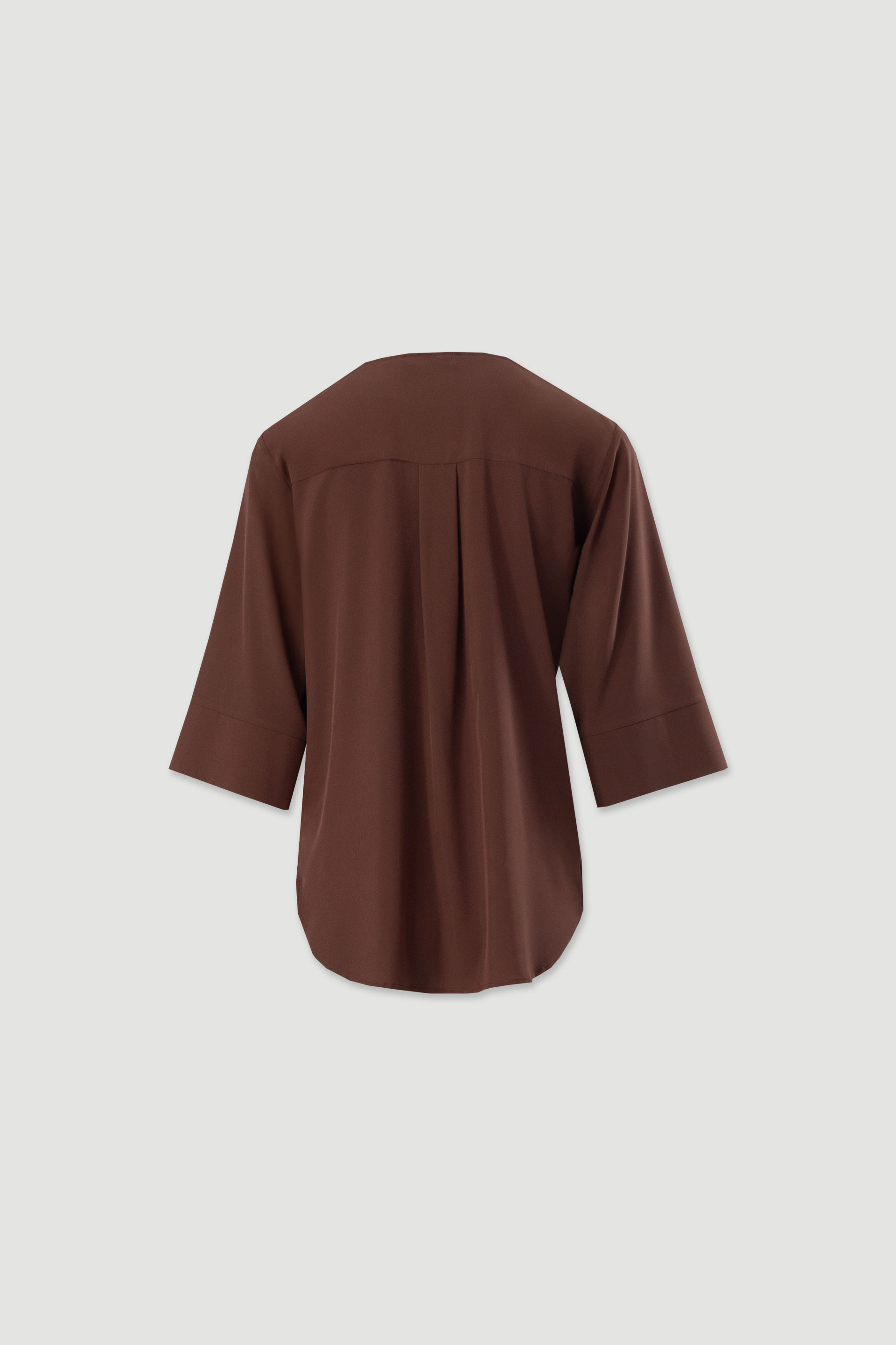 Asymmetric tunic with metallic detail on the neckline