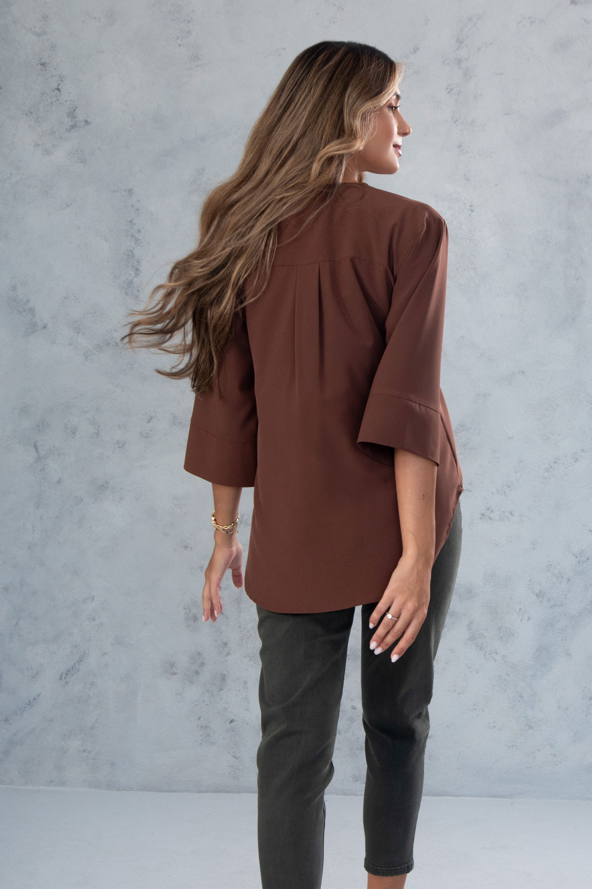 Asymmetric tunic with metallic detail on the neckline