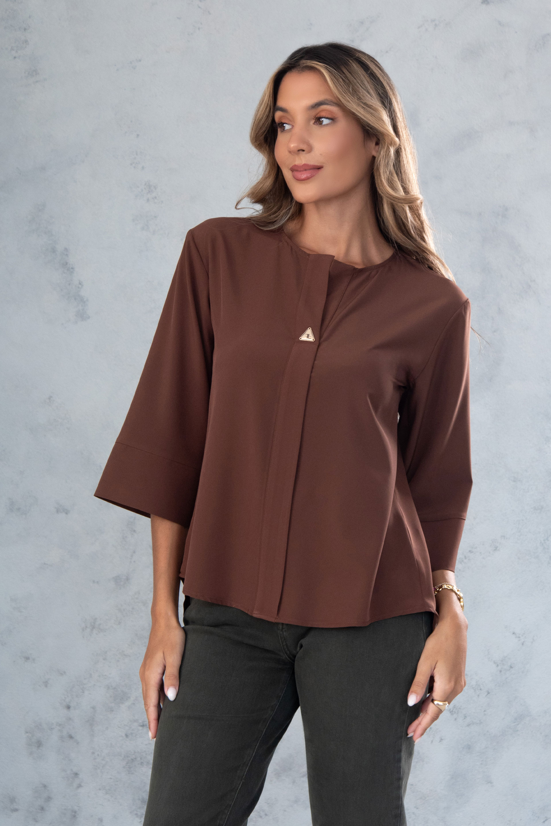 Asymmetric tunic with metallic detail on the neckline