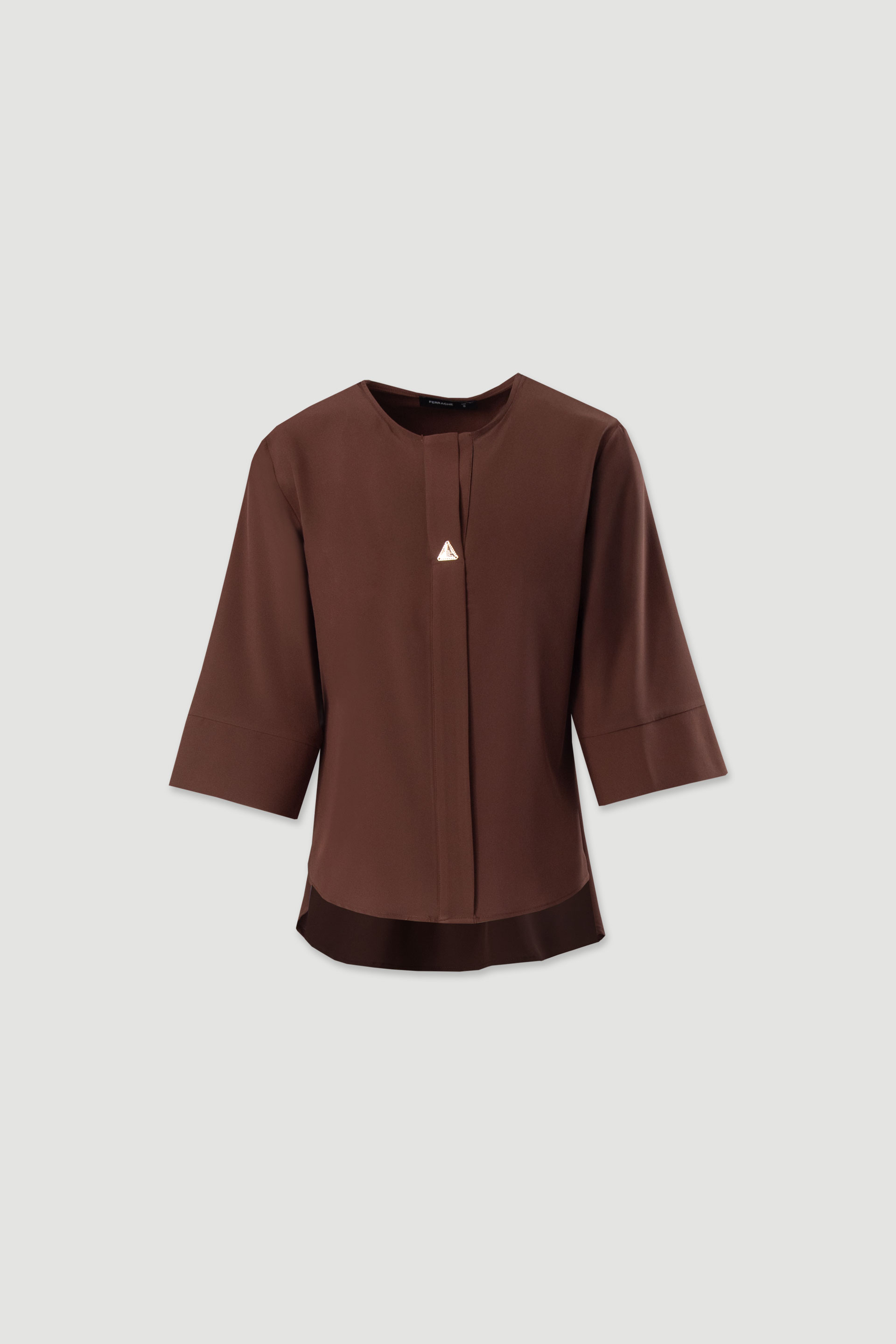 Asymmetric tunic with metallic detail on the neckline