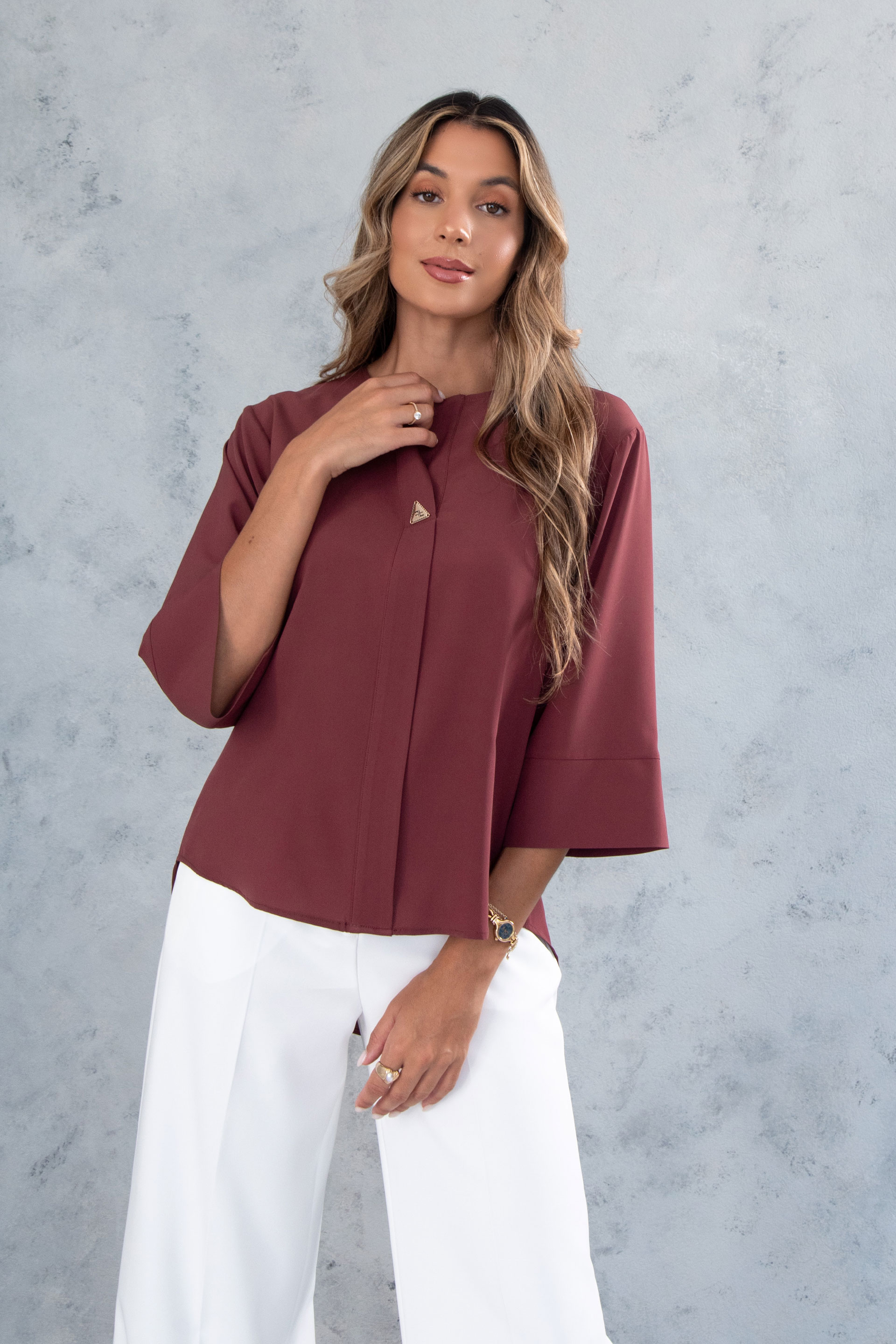 Asymmetric tunic with metallic detail on the neckline