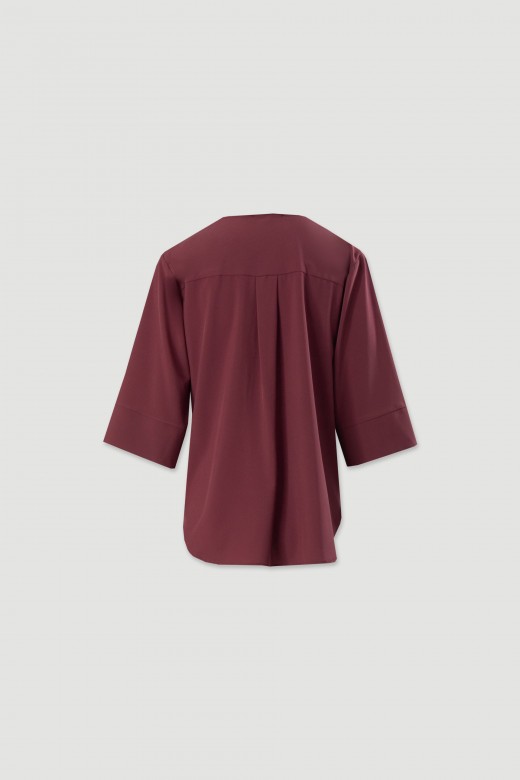 Tunique asymtrique avec dtail mtallique  lencolure
