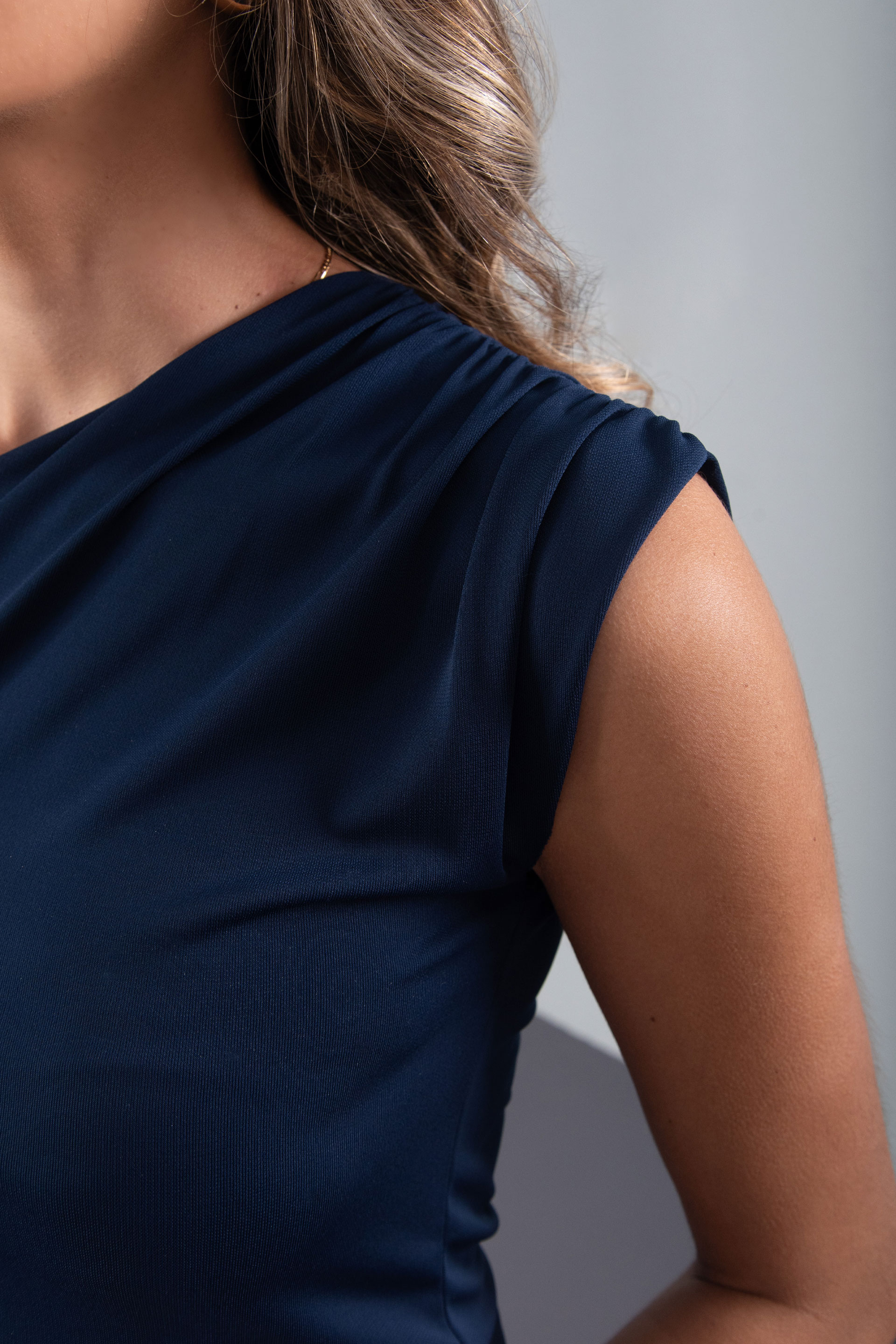 Knit top with asymmetric neckline