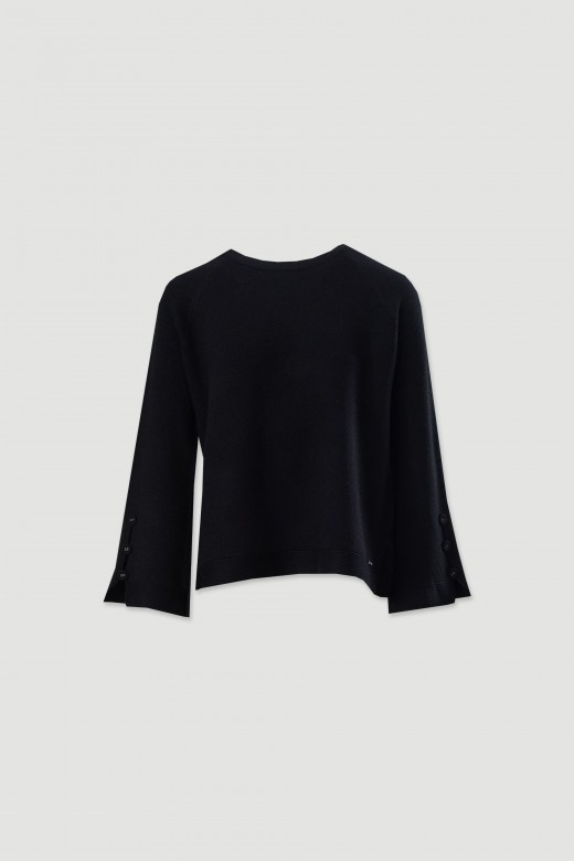 Knitted sweater with decorative sleeve buttons