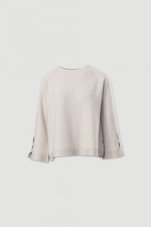 Knitted sweater with decorative sleeve buttons