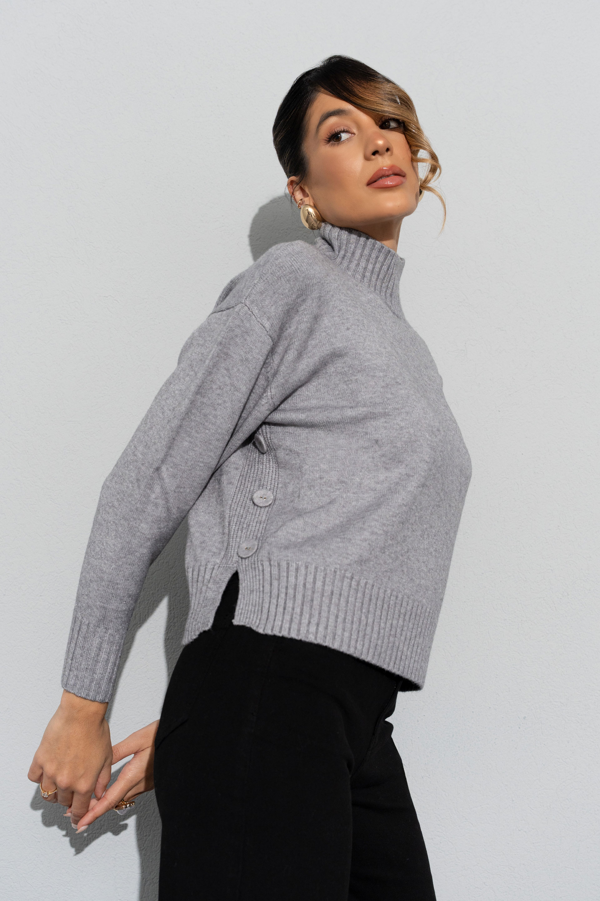 Jersey de punto con cuello alto y botones laterales
