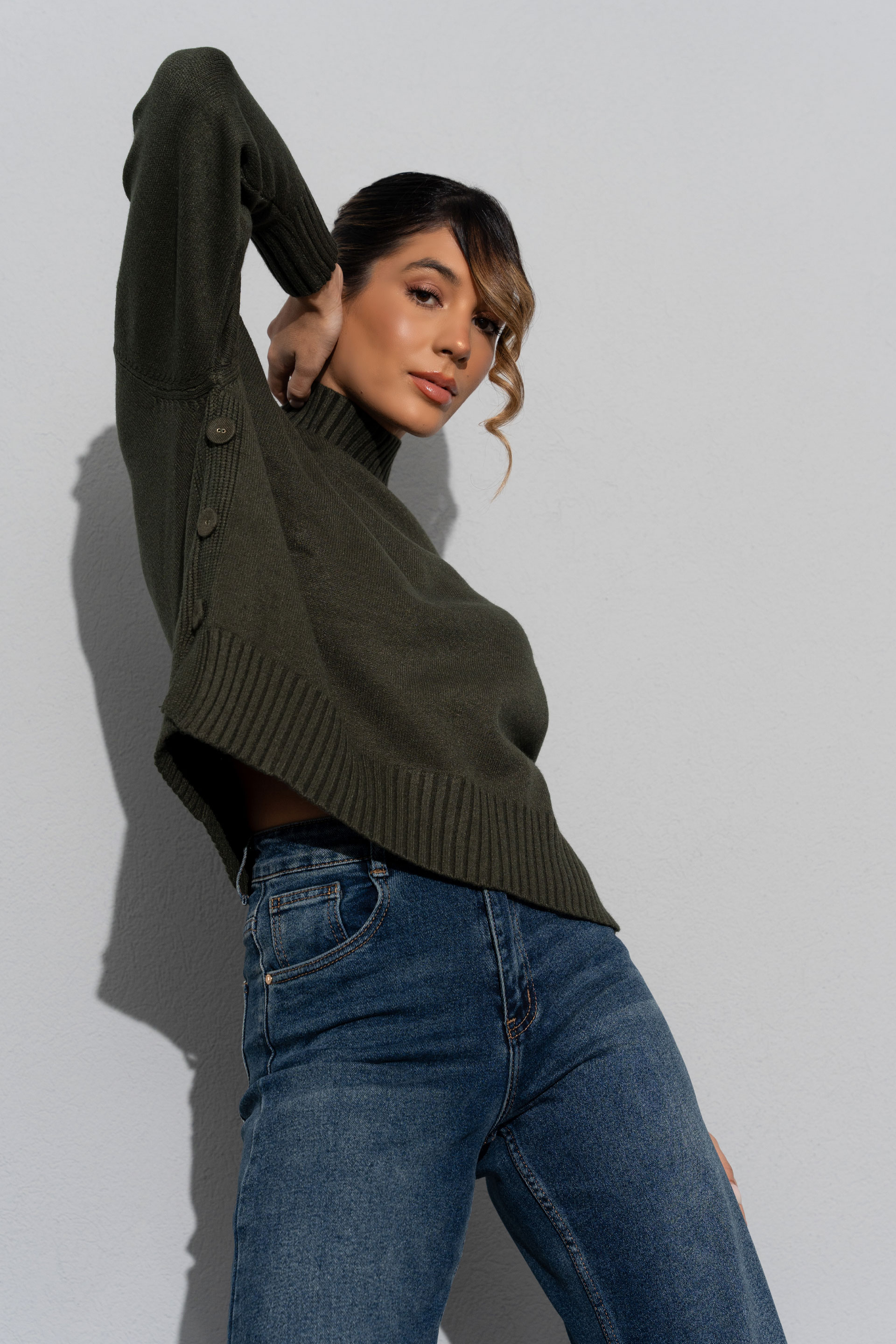 Knit sweater with high neck and side buttons