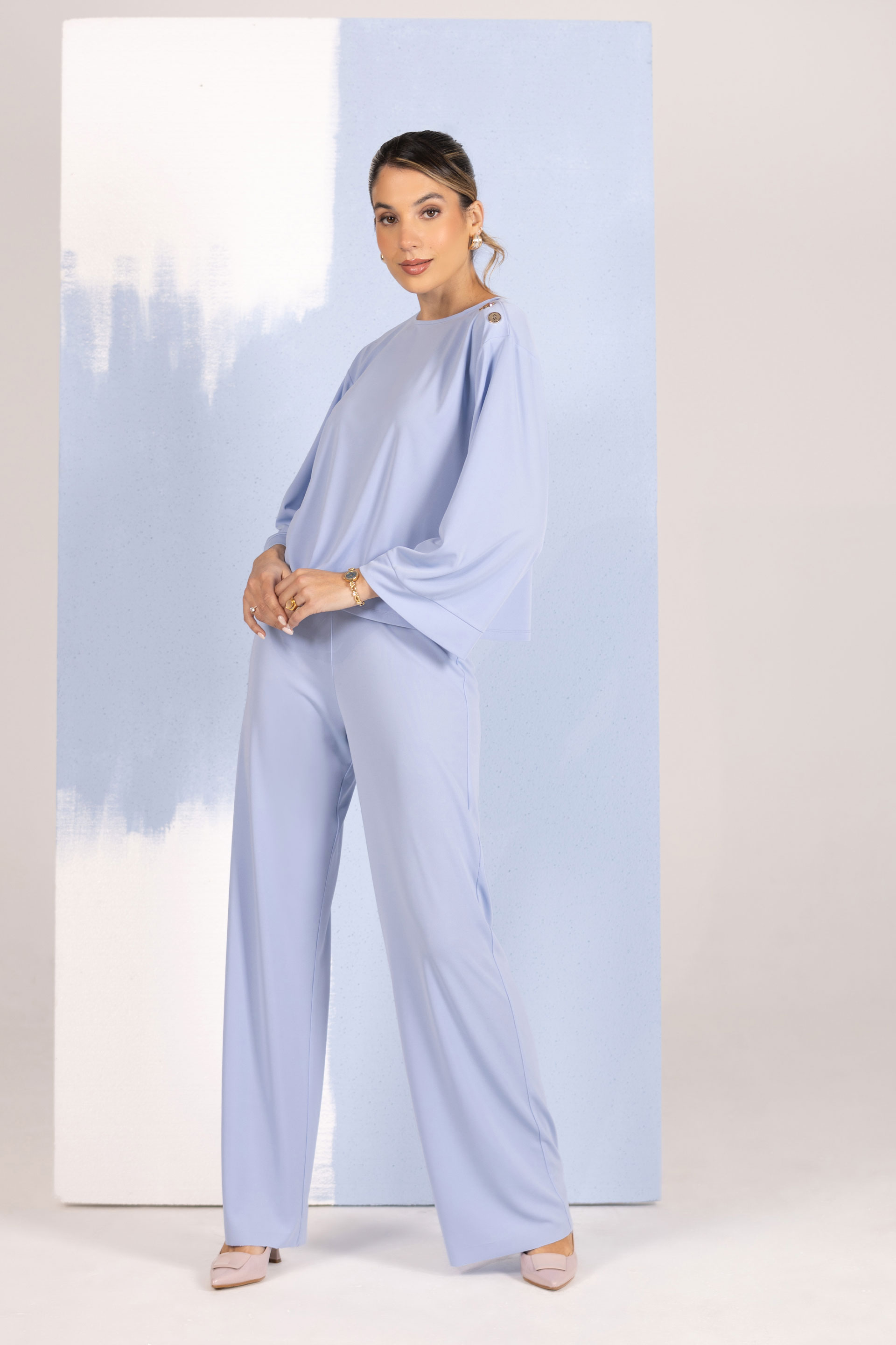 Tunic with decorative shoulder buttons
