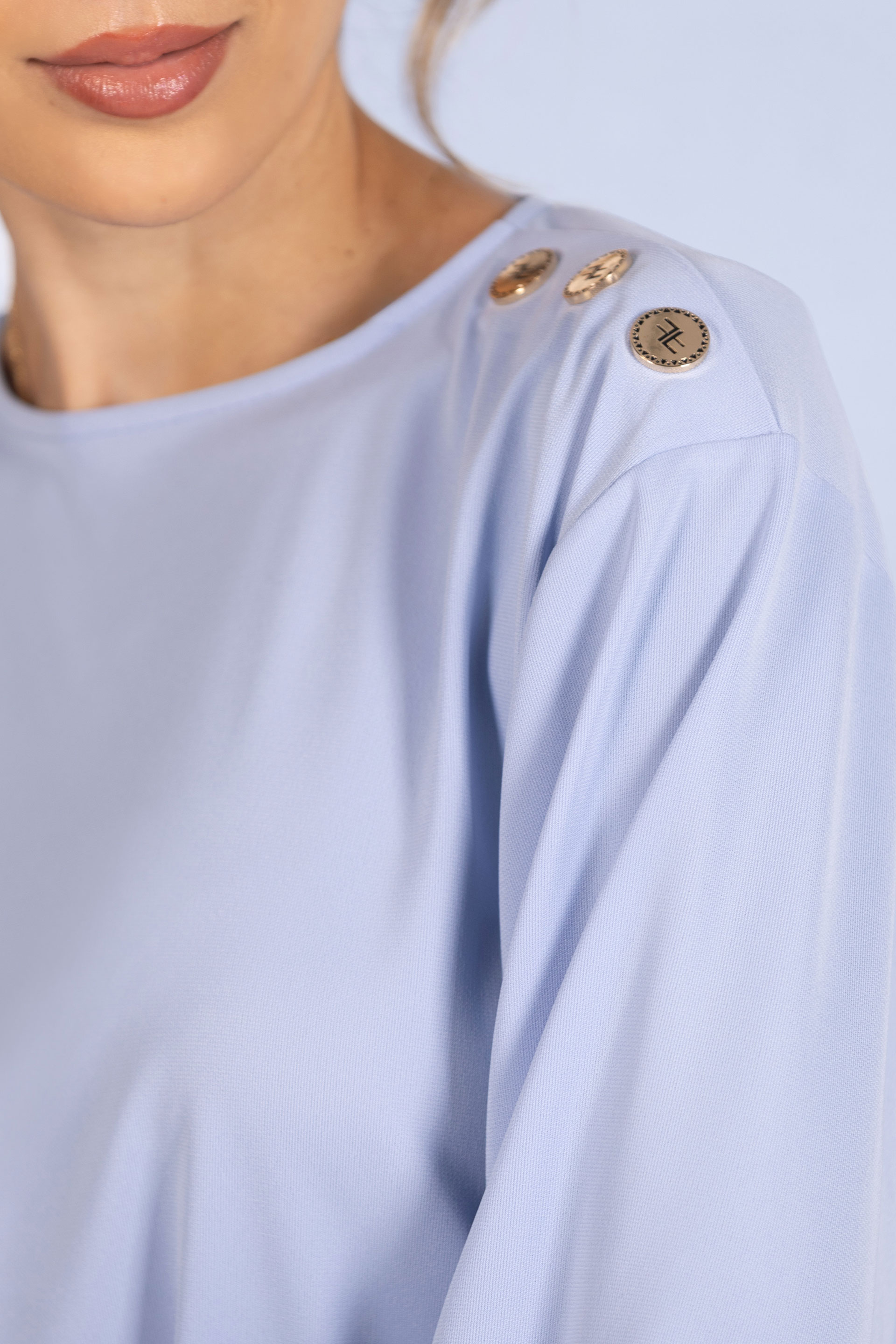 Tunic with decorative shoulder buttons