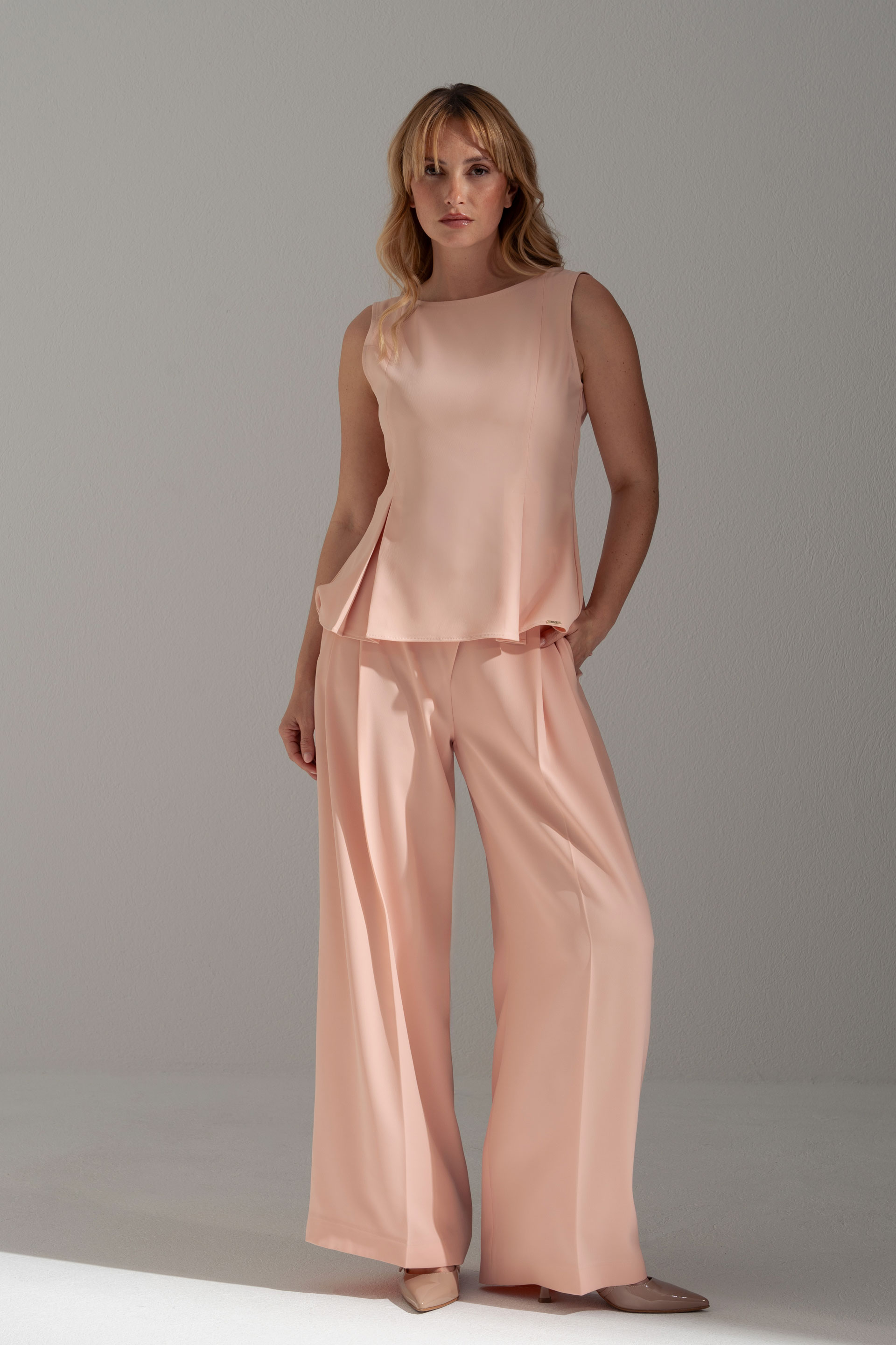 Sleeveless flowing top with side slits