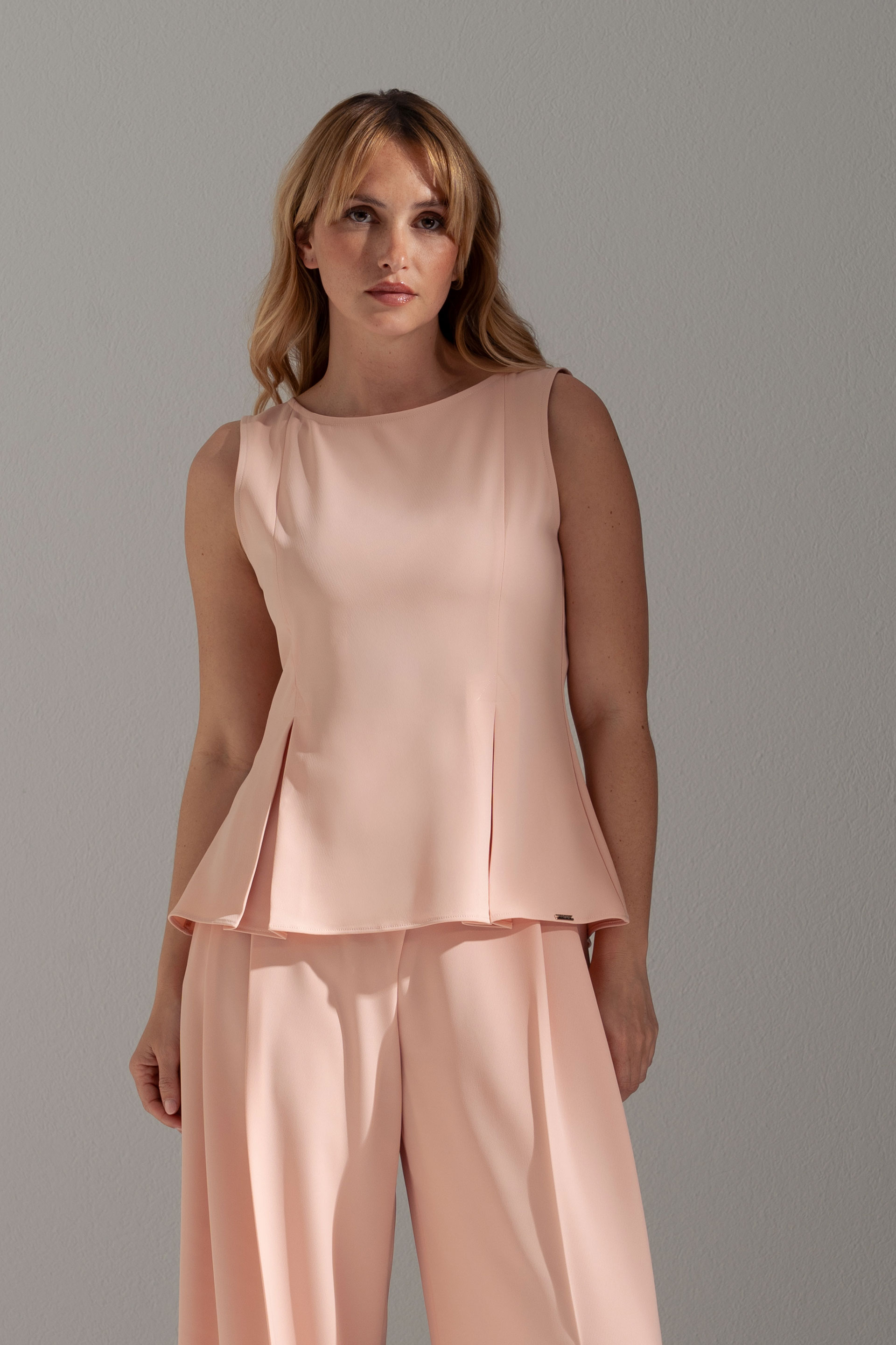 Sleeveless flowing top with side slits