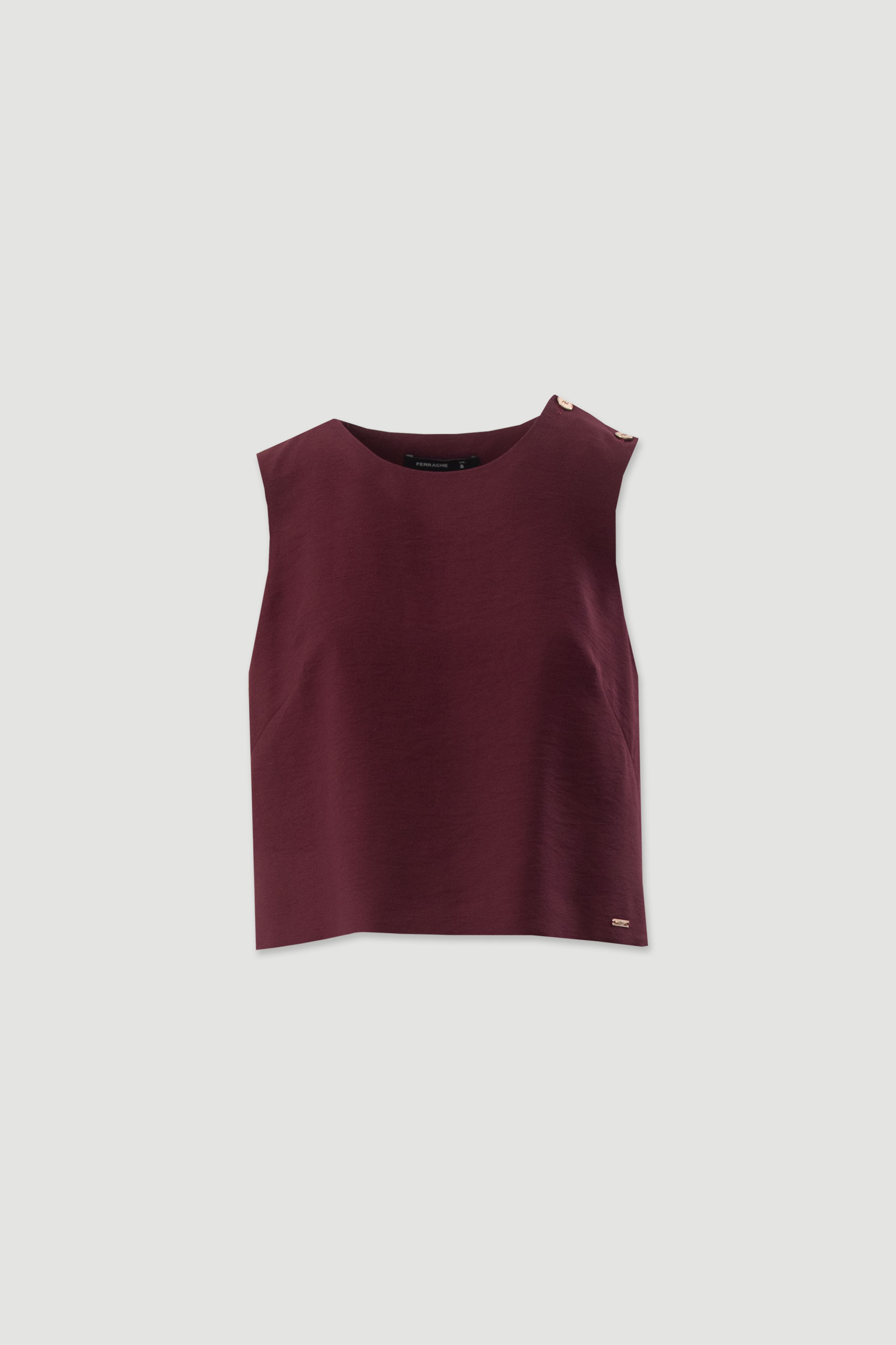 Cropped top with gold buttons on the shoulder